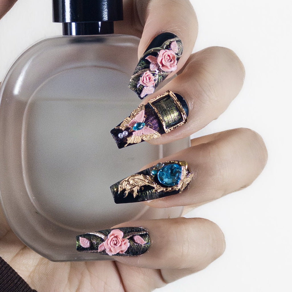 Close-up texture shot of Velvetkay Baroque Rose press-on nails in Coffin shape. Handcrafted ornate design detail.