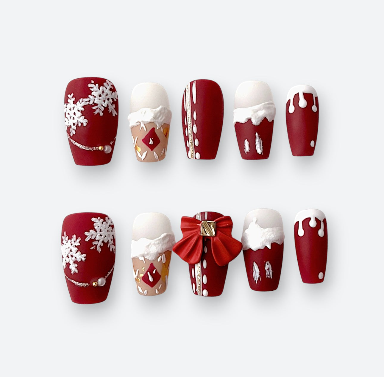 Full set view of 10 Velvetkay Crimson Noel handcrafted press-on nails. Festive red luxury design.