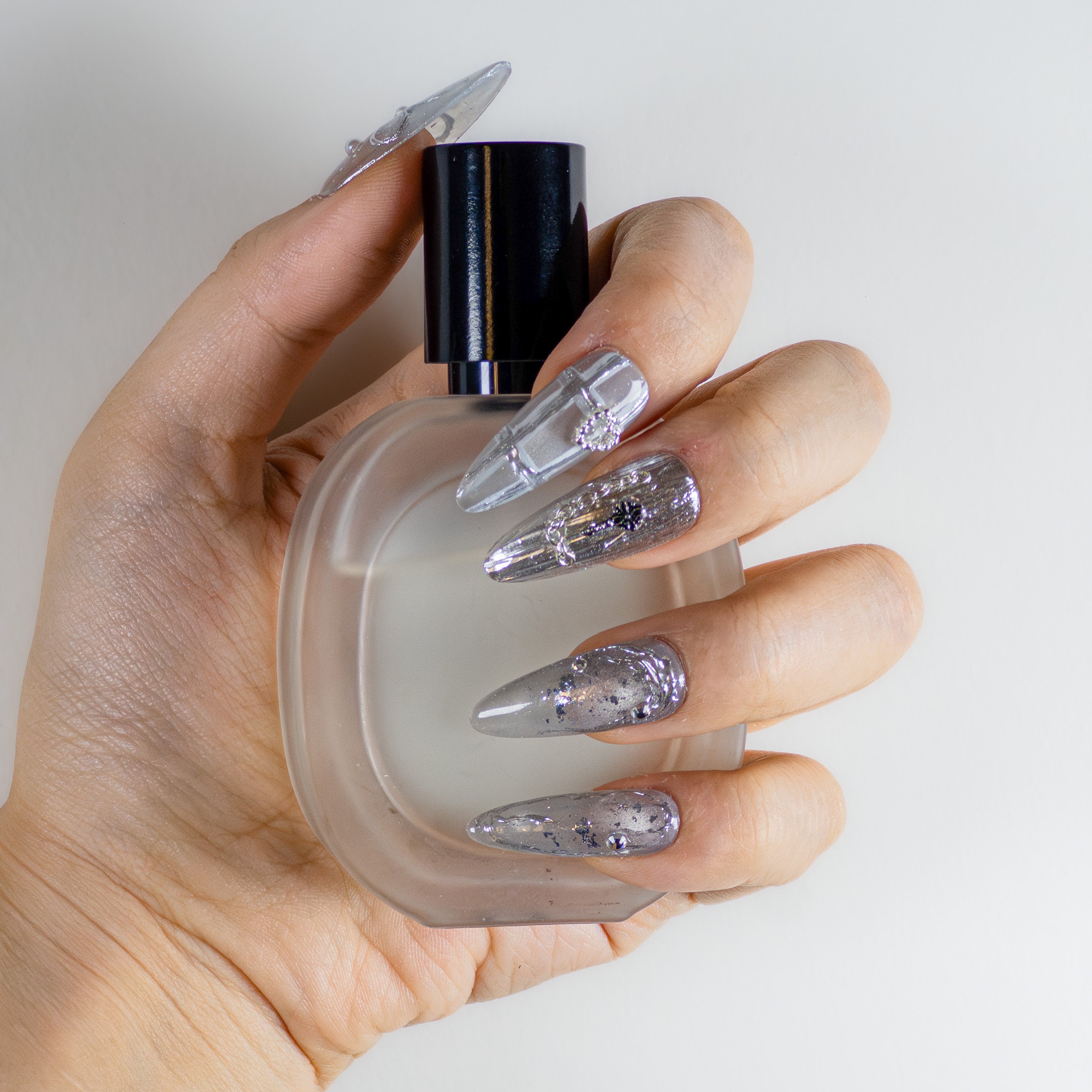 Molten silver chrome and gothic 3D textured long stiletto luxury reusable gel nails by Velvetkay.