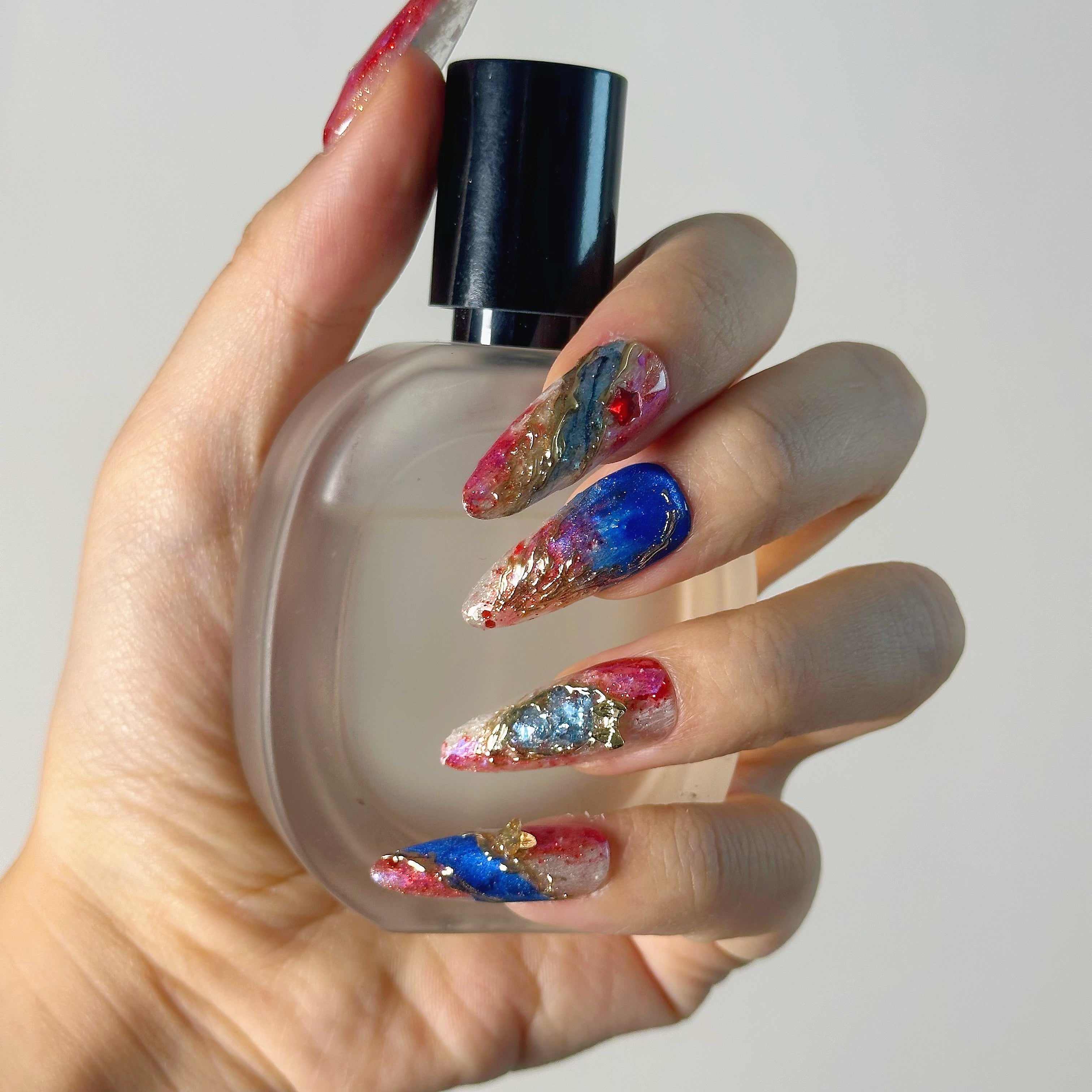 Abstract celestial blue and red marble long almond luxury reusable structured gel nails with gold foil by Velvetkay.