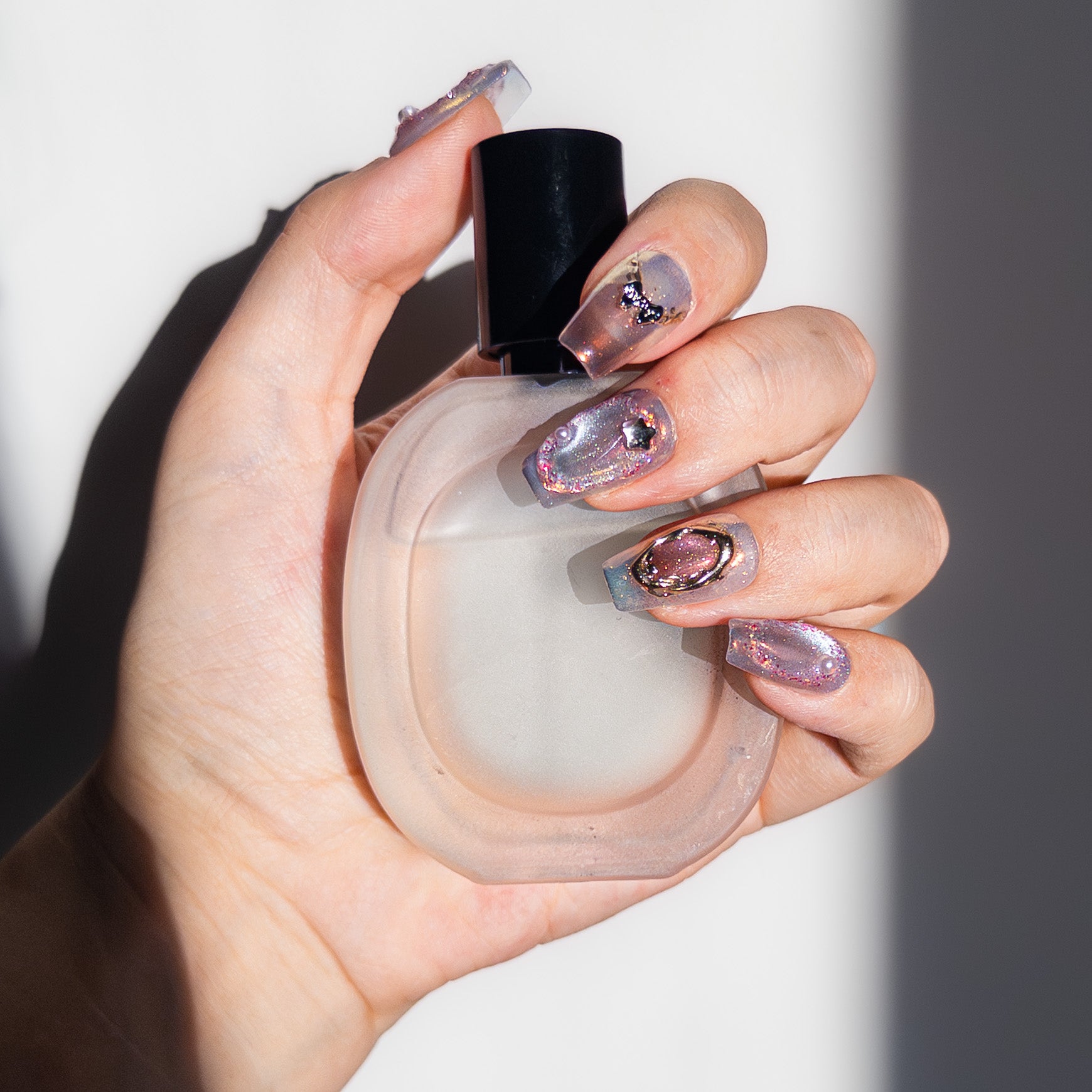 High-gloss lavender aurora glitter texture with pearls and chrome accents on durable reusable handmade gel nails.