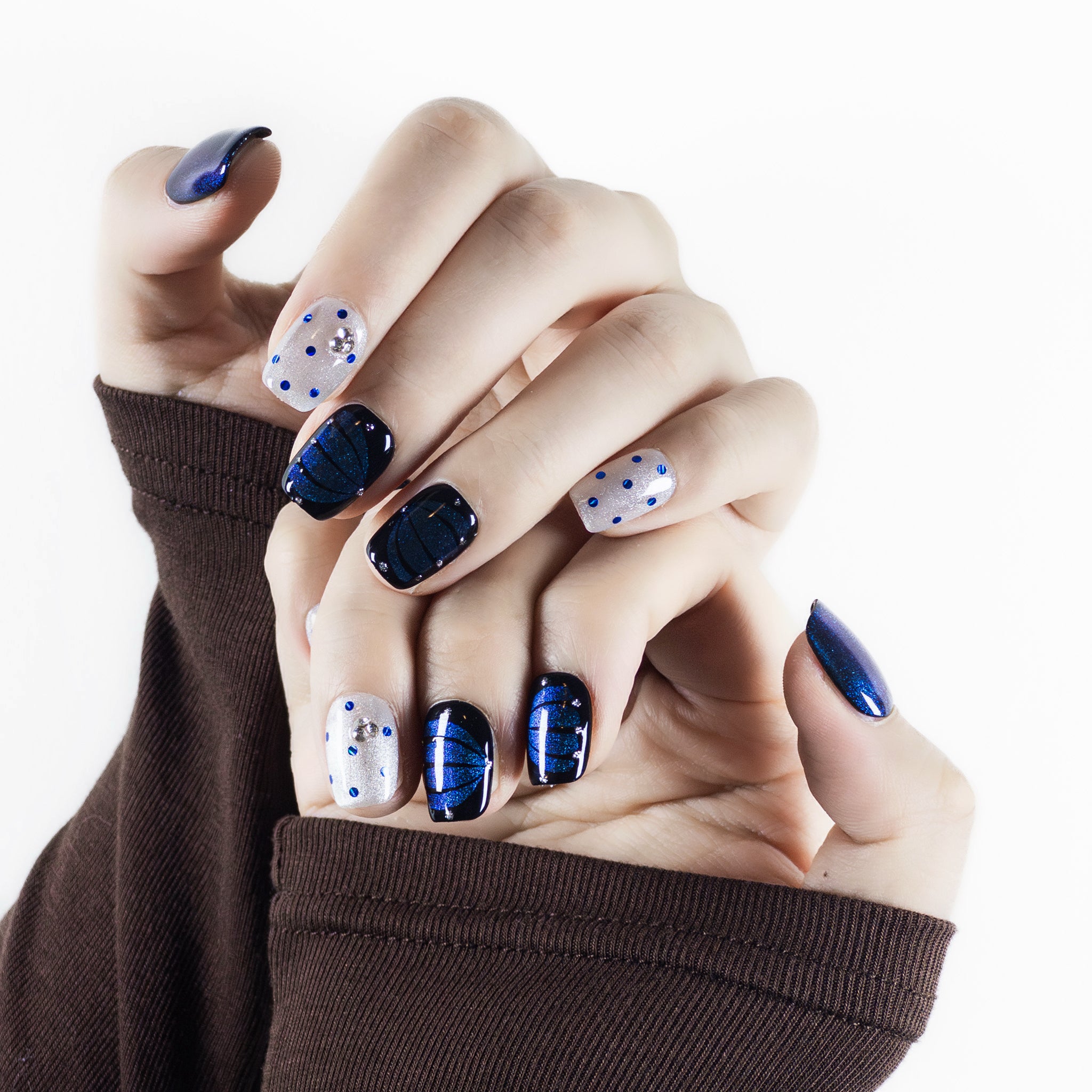 Close-up detail of Velvetkay Obsidian Night nails in Square shape. Hand-finished edge and surface texture.