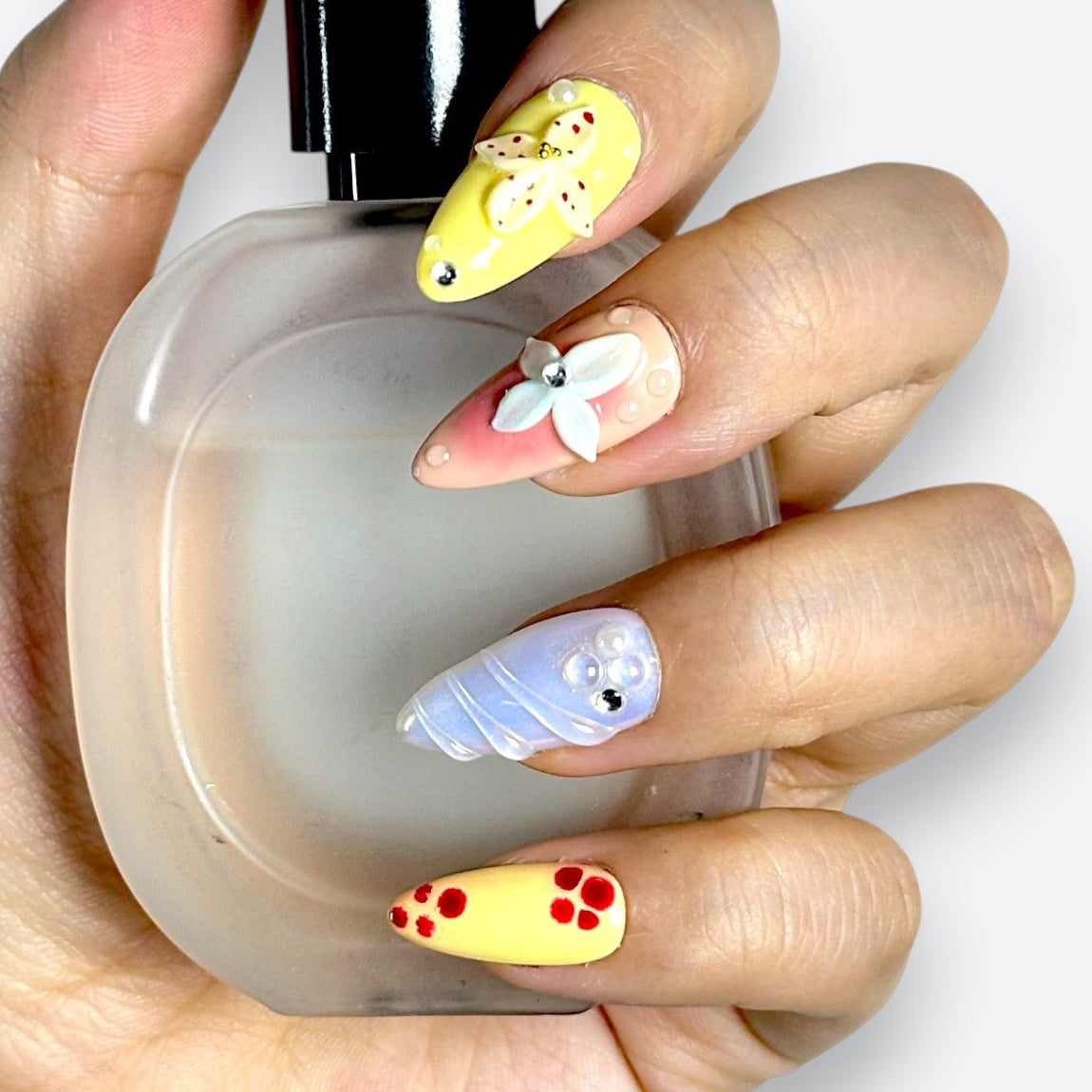 Close-up of Velvetkay Pastel Garden press-on nails. Soft, multi-colored design inspired by spring florals.