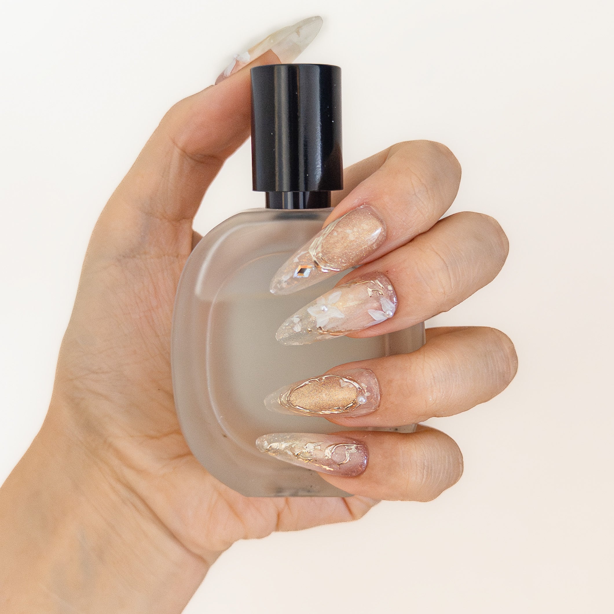 Ethereal champagne gold shimmer floral long almond luxury reusable structured gel nails by Velvetkay.