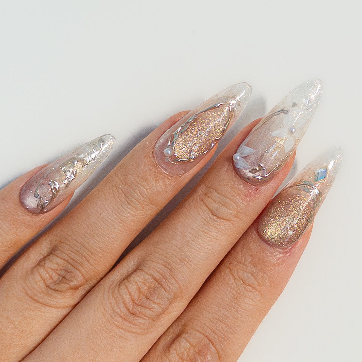 Sculpted gold chrome borders encasing champagne glitter on high-gloss wearable art structure gel.