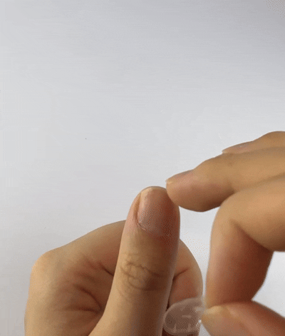 Step 5: Applying the adhesive tab to the natural nail and removing the protective film.