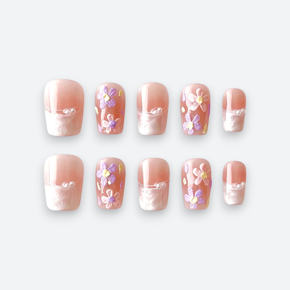 Full set view of Velvetkay Blush Meadow handcrafted press-on nails. Includes 10 reusable nails in soft pink design.
