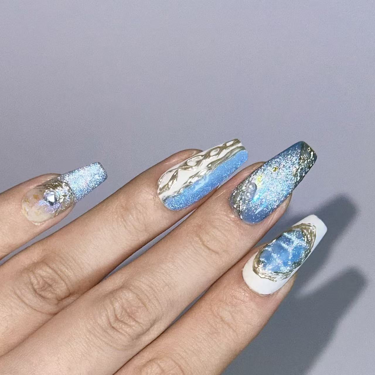 Close-up texture shot of Velvetkay Glacier Sonata press-on nails in Coffin shape. Hand-painted art detail.