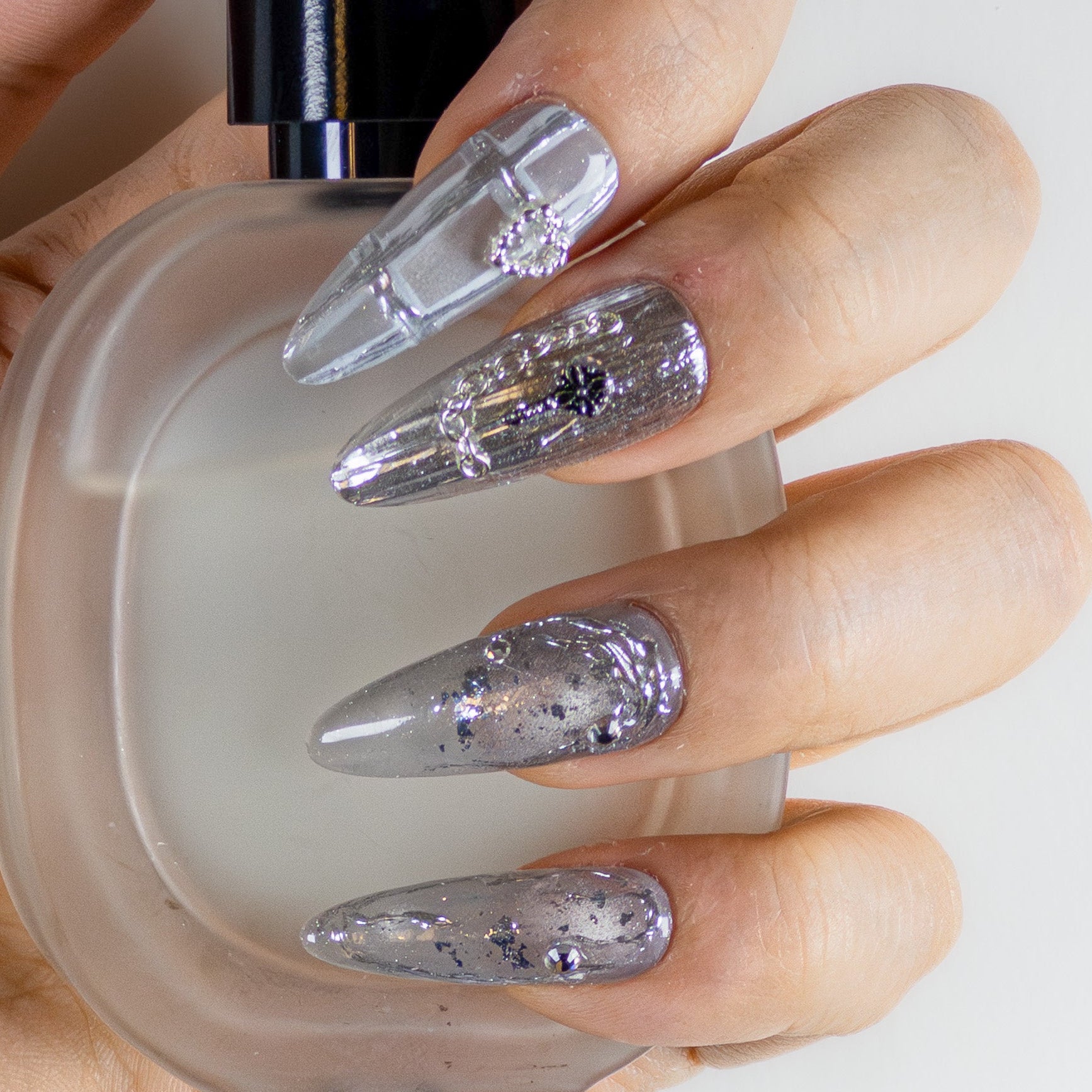 Molten silver chrome and gothic 3D textured long stiletto luxury reusable gel nails by Velvetkay.