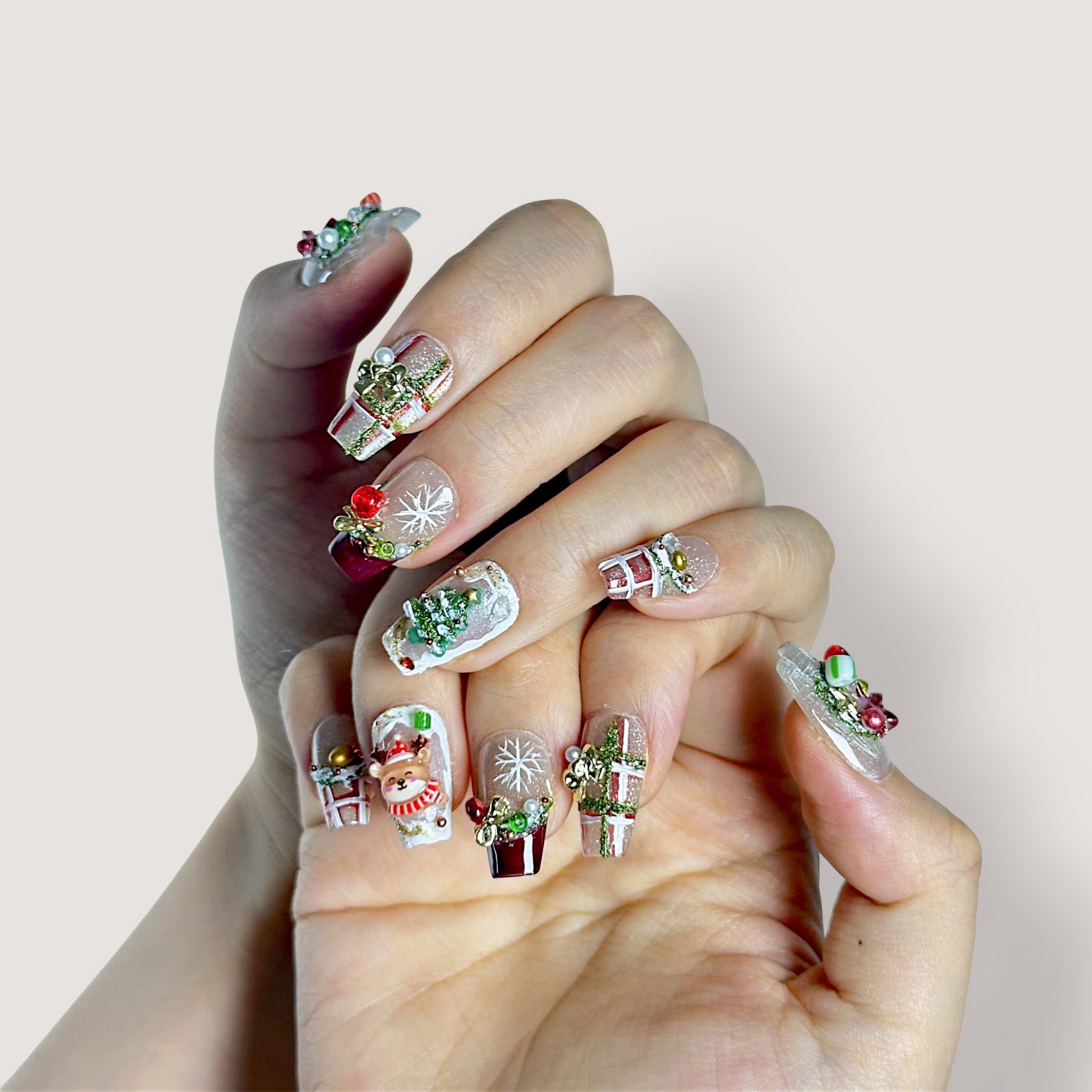 Holiday Jubilee intricate Christmas press-on nails with 3D reindeer and snowflake art, coffin shape structured gel by Velvetkay.