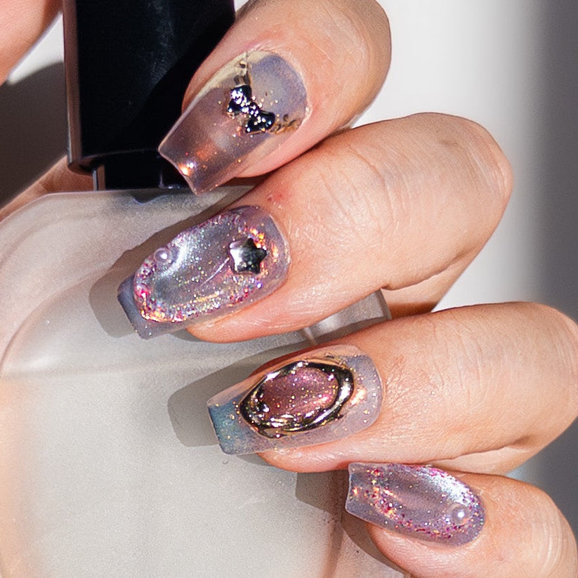 High-gloss lavender aurora glitter texture with pearls and chrome accents on durable reusable handmade gel nails.