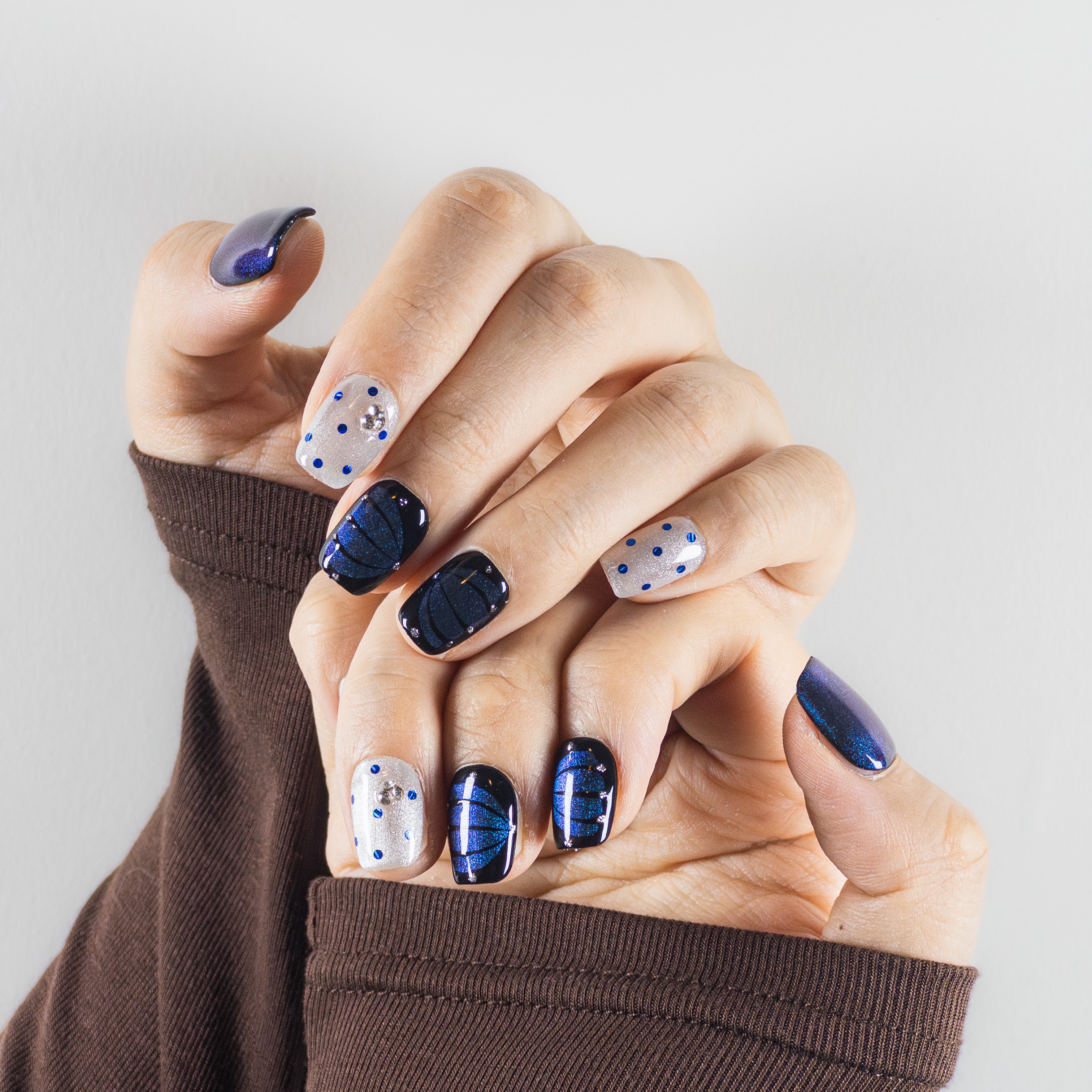 Obsidian Night galaxy-inspired midnight blue magnetic gel nails with hand-painted dots, square shape reusable art by Velvetkay.