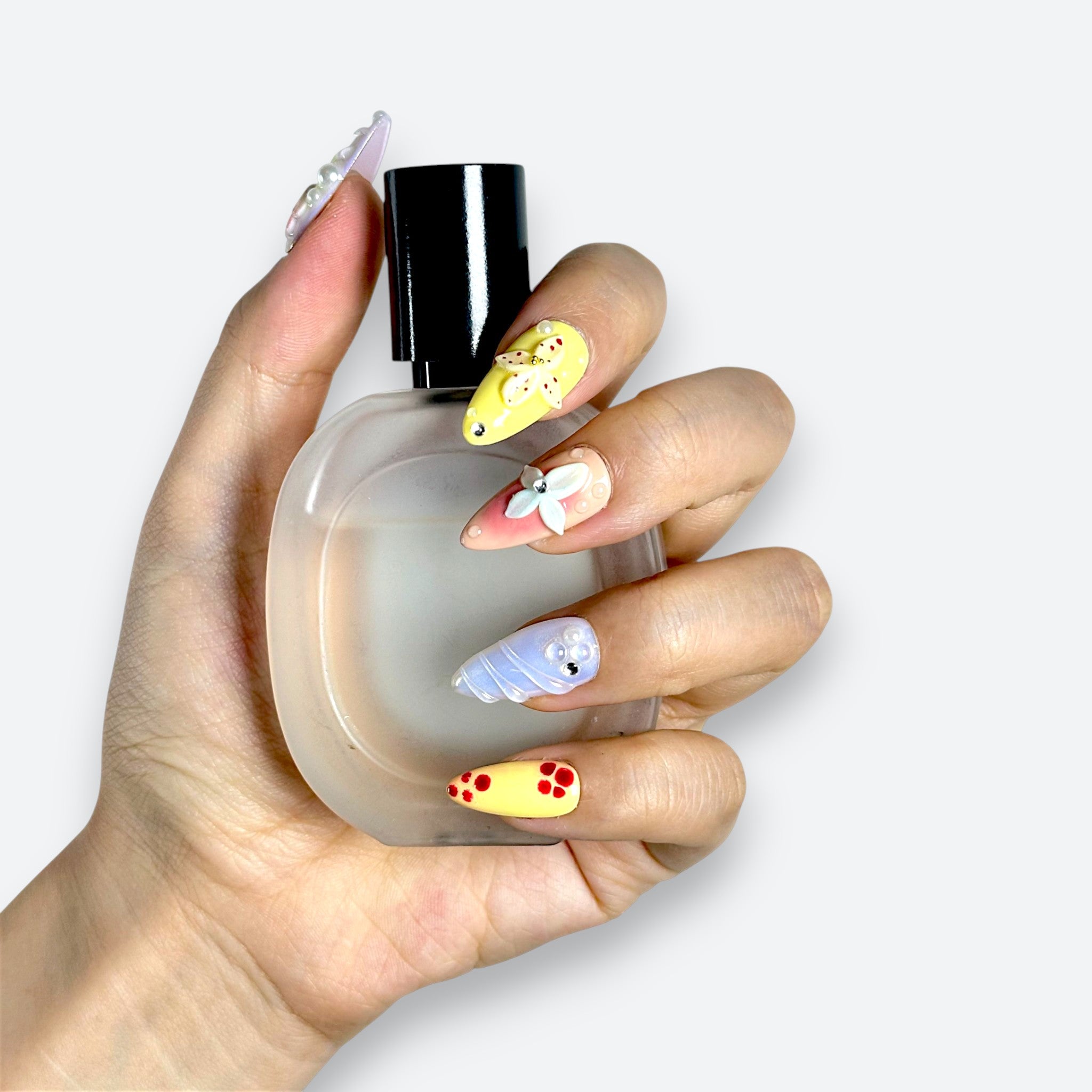 Close-up of Velvetkay Pastel Garden press-on nails. Soft, multi-colored design inspired by spring florals.