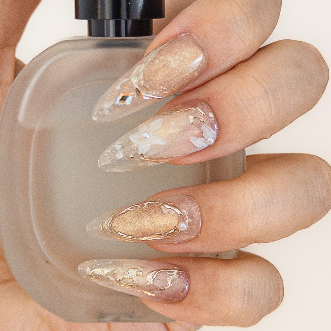 Ethereal champagne gold shimmer floral long almond luxury reusable structured gel nails by Velvetkay.