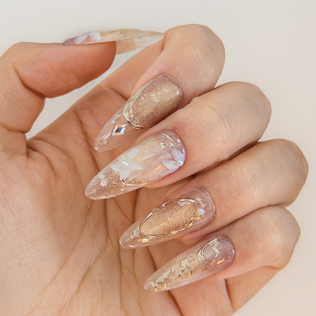 Magnetic gold cat-eye effect with rhombus crystal accent and textured metallic art on durable faux-acrylic structure gel.