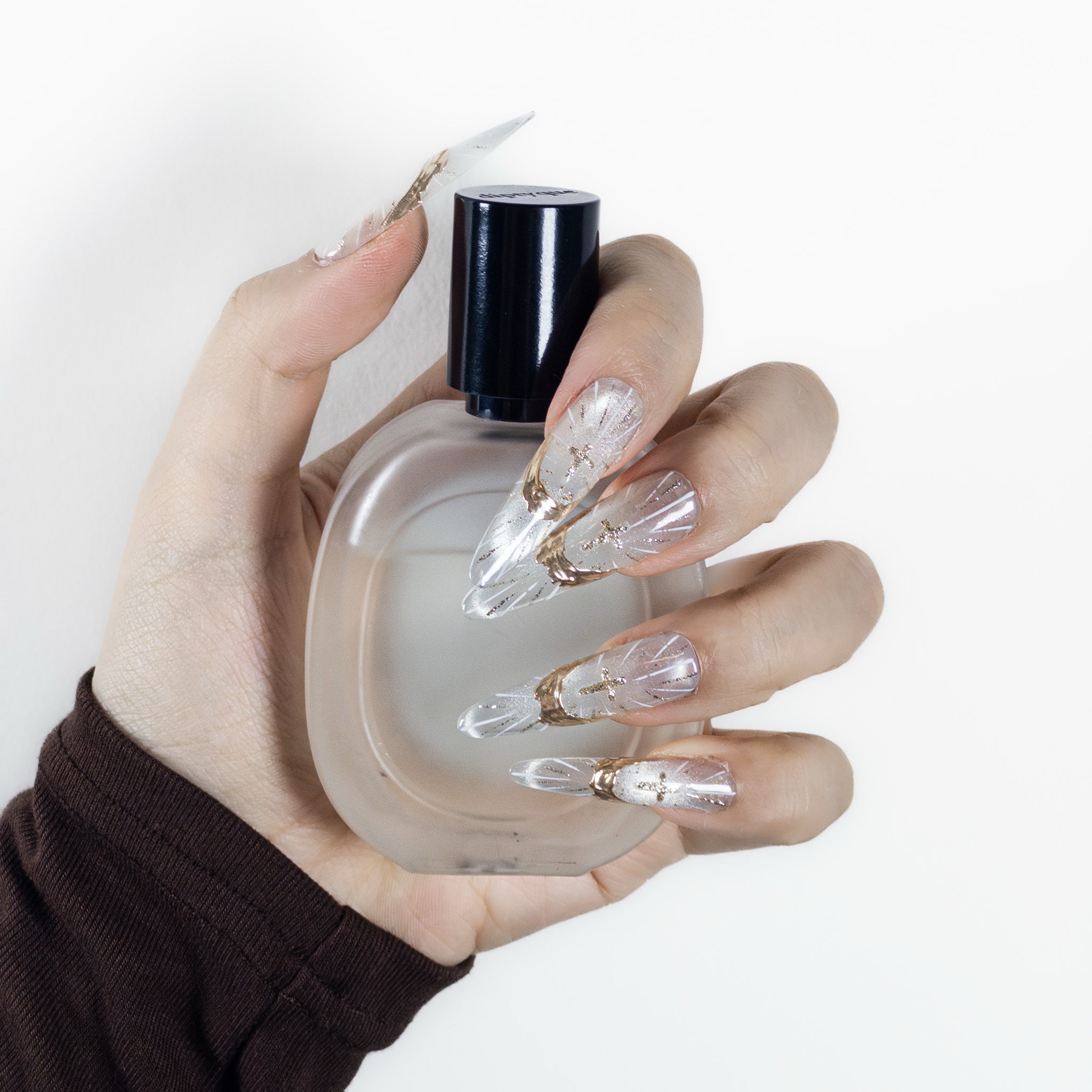 Side profile view of Velvetkay Sanctum Glow Stiletto nails, highlighting the natural curvature and fit.